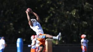 Football player catching a pass during a game at Pensacola State College.