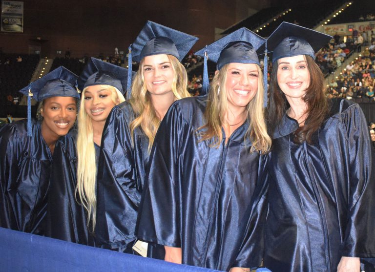 Graduates in caps and gowns at Pensacola State College December graduation at Bay Center.