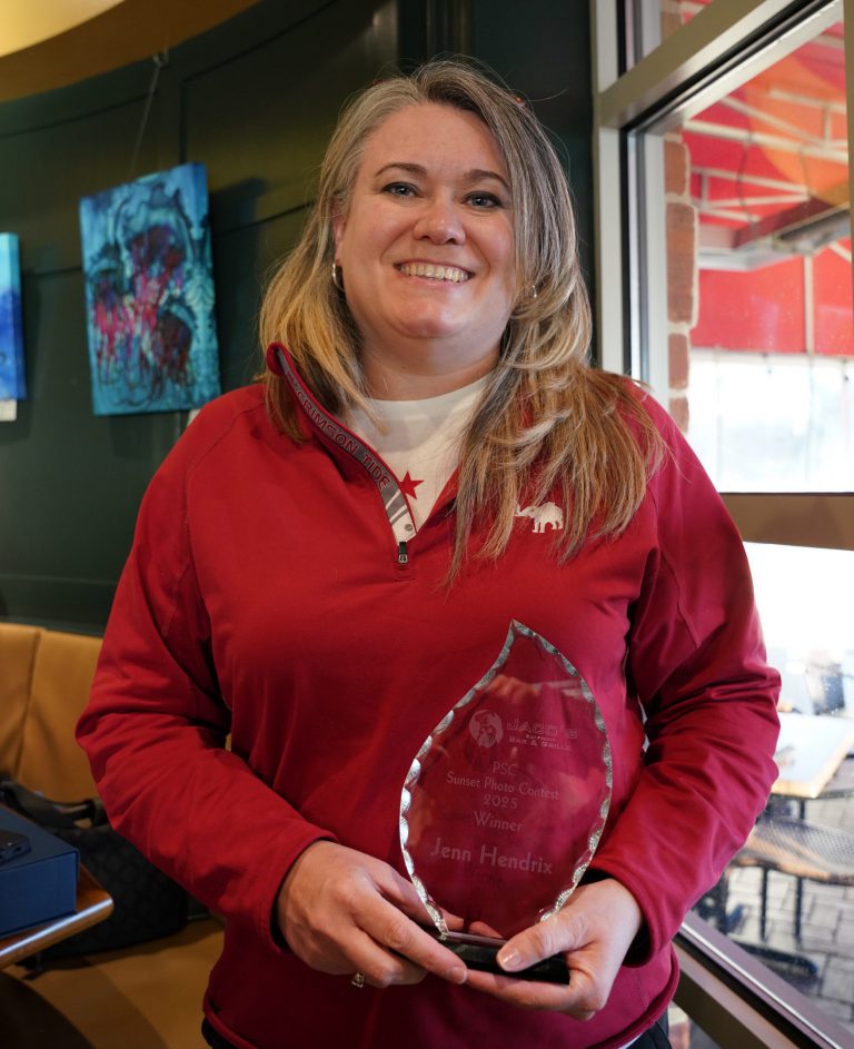 Student photographer with award at Jaco&rsquo;s PSC Sunset Photography Contest.