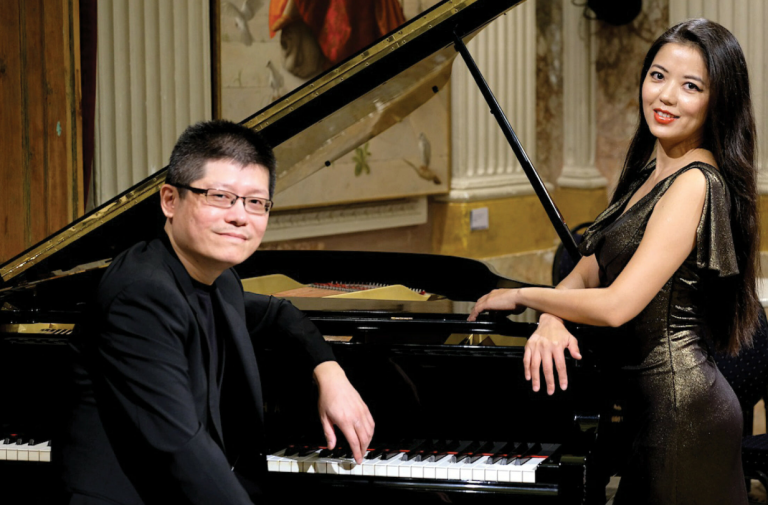Elegant duo playing piano during a concert at Pensacola State College event.