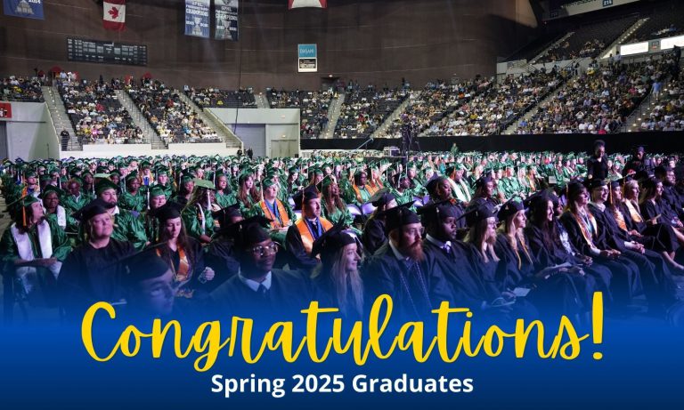 Graduates in caps and gowns at Pensacola State College commencement ceremony, celebrating the Class.