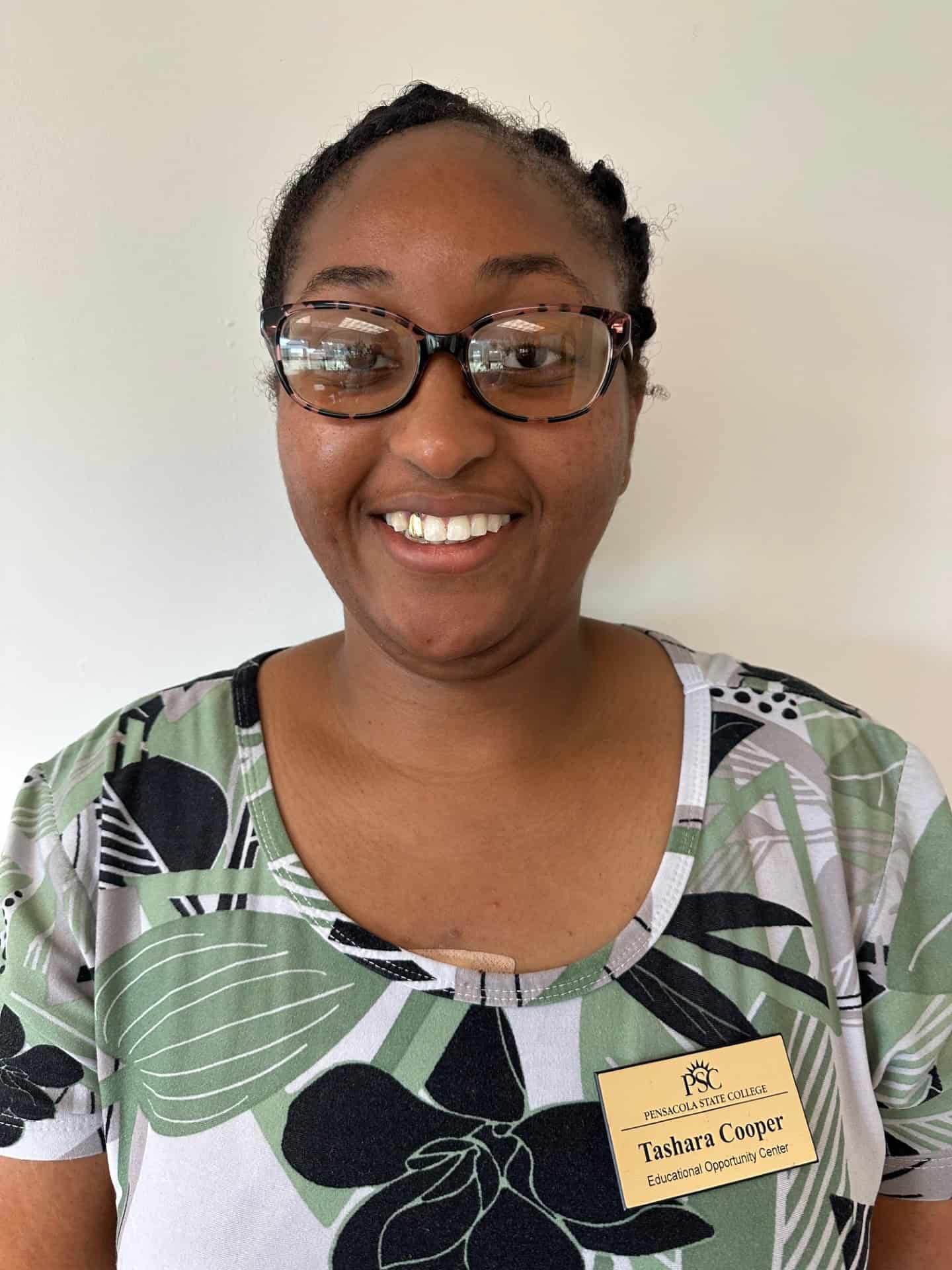Diverse student smiling with name tag at TRIO event.