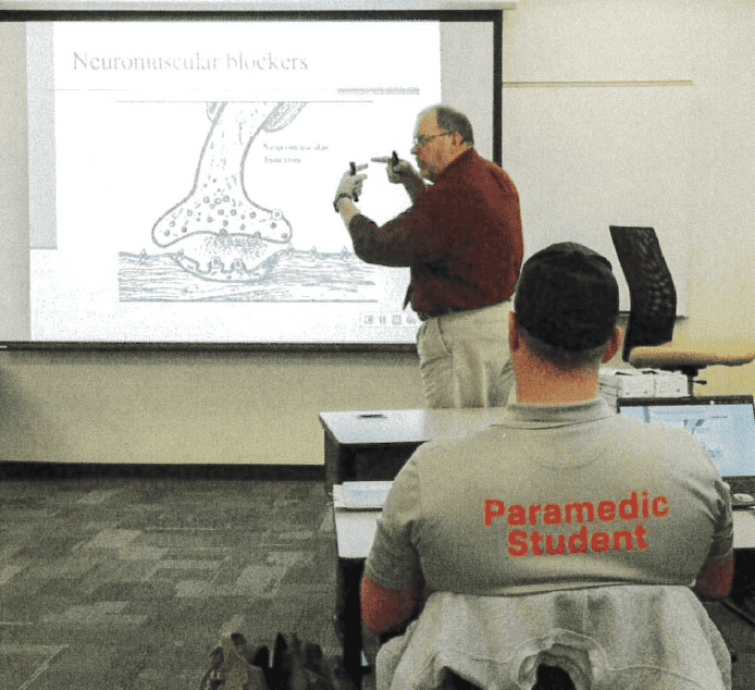 Paramedic student learning emergency response techniques in classroom training.
