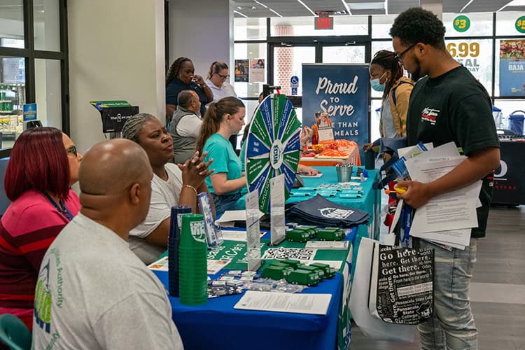 Students and job seekers engaging at Pensacola State College career fair promoting technical educati.