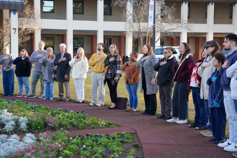 Saluting the red, white, and blue during a patriotic event at Pensacola State College.