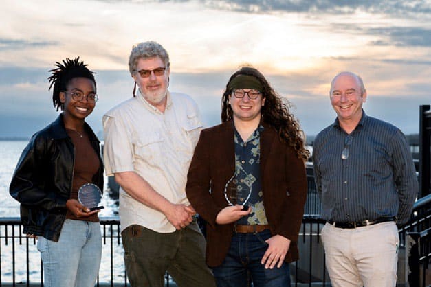 Andrew Johnson and team celebrating sunset photography contest victory at Pensacola State College.